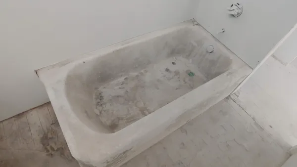 Comparison of old burnt bathtub vs brand new white reglazed tub